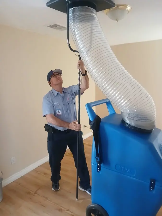 Furnace Tune-Up technician using HEPA equipment in St. Augustine